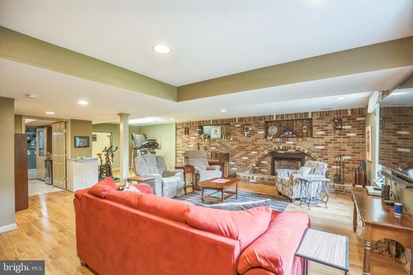 Fireplace, Interior, Living room, Recessed Lighting, Stone Walls, Wood Texture Flooring