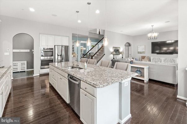 Chandelier, Dining room, Interior, Kitchen, Living room, Pendant Lights, Recessed Lighting, Stainless Steel Appliances, Wood Texture Flooring