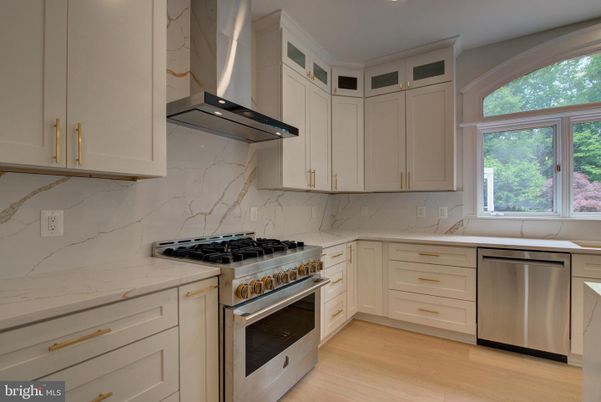 Interior, Kitchen, Marble Walls, Recessed Lighting, Stainless Steel Appliances, Wood Texture Flooring