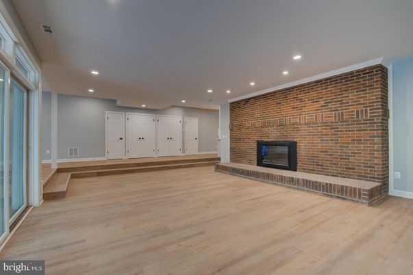 Empty room, Fireplace, Interior, Recessed Lighting, Stone Walls, Wood Texture Flooring