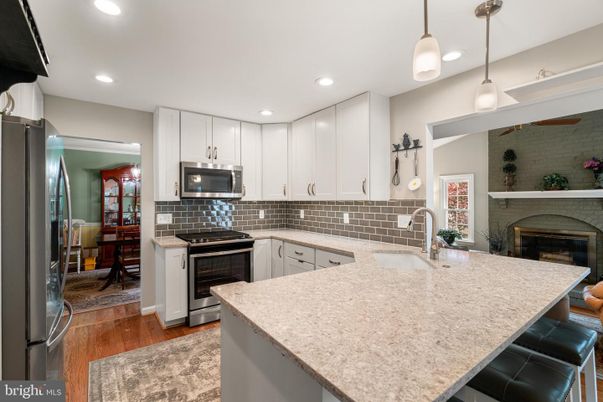 Fireplace, Interior, Kitchen, Pendant Lights, Recessed Lighting, Stainless Steel Appliances, Wood Texture Flooring
