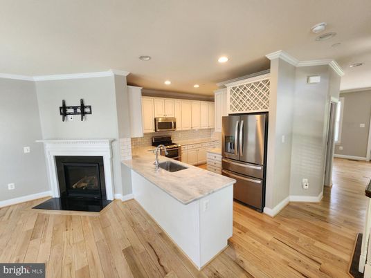 Fireplace, Interior, Kitchen, Recessed Lighting, Stainless Steel Appliances, Wood Texture Flooring