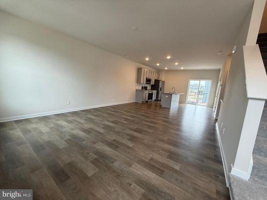 Empty room, Interior, Kitchen, Recessed Lighting, Stainless Steel Appliances, Wood Texture Flooring