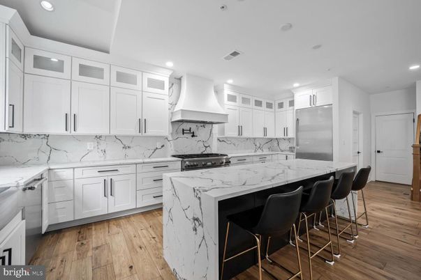 Interior, Kitchen, Marble Walls, Recessed Lighting, Stainless Steel Appliances, Wood Texture Flooring