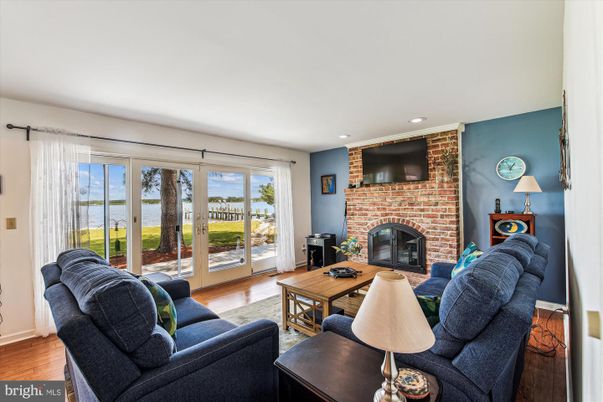 Fireplace, Interior, Living room, Recessed Lighting, Stone Walls, Water, Wood Texture Flooring