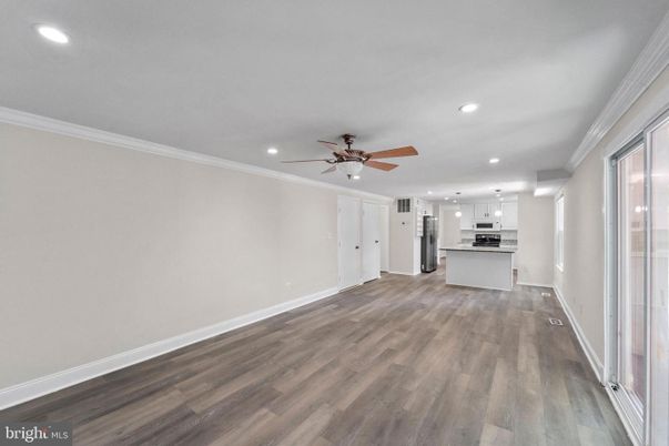 Empty room, Interior, Kitchen, Recessed Lighting, Stainless Steel Appliances, Wood Texture Flooring