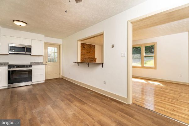 Empty room, Interior, Kitchen, Stainless Steel Appliances, Wood Texture Flooring