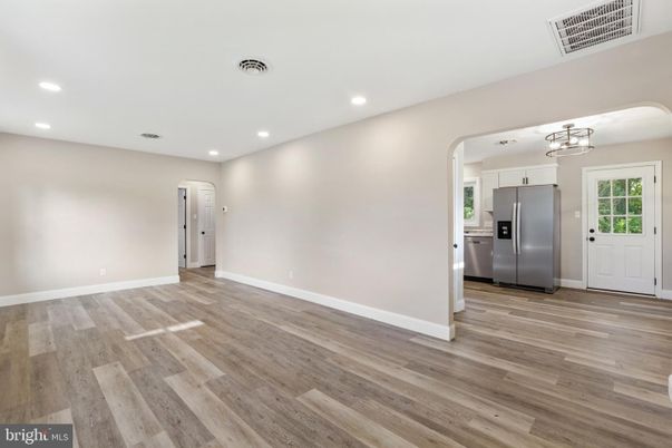 Empty room, Interior, Kitchen, Recessed Lighting, Stainless Steel Appliances, Wood Texture Flooring