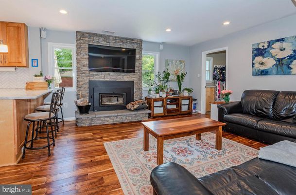 Fireplace, Interior, Living room, Recessed Lighting, Stone Walls, Wood Texture Flooring