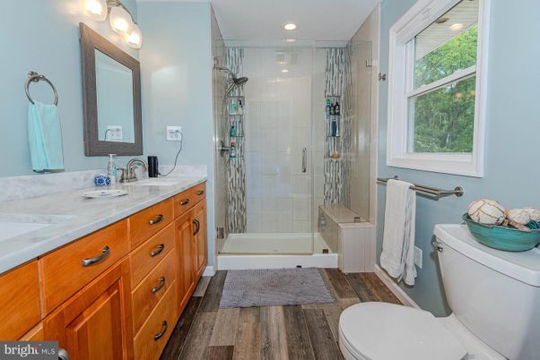 Bathroom, Dual Sink Vanities, Glass Shower, Interior, Recessed Lighting, Wood Texture Flooring