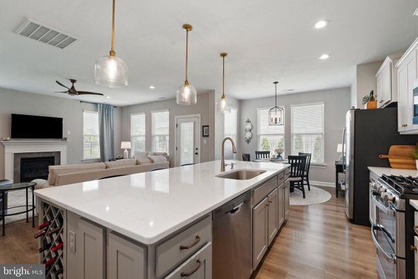 Dining room, Fireplace, Interior, Kitchen, Living room, Pendant Lights, Recessed Lighting, Stainless Steel Appliances, Wood Texture Flooring