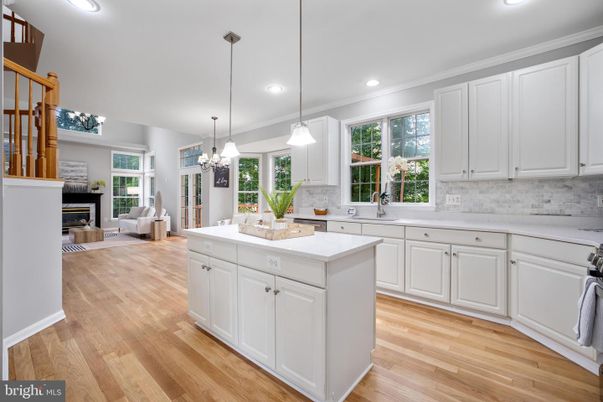 Chandelier, Fireplace, Interior, Kitchen, Living room, Pendant Lights, Recessed Lighting, Wood Texture Flooring