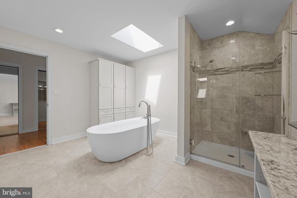 Bathroom, Free Standing Baths, Glass Shower, Interior, Recessed Lighting, Wood Texture Flooring