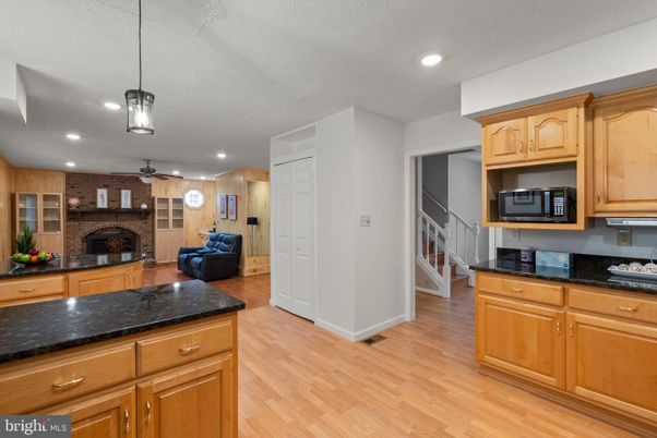 Fireplace, Interior, Kitchen, Pendant Lights, Recessed Lighting, Stone Walls, Wood Texture Flooring