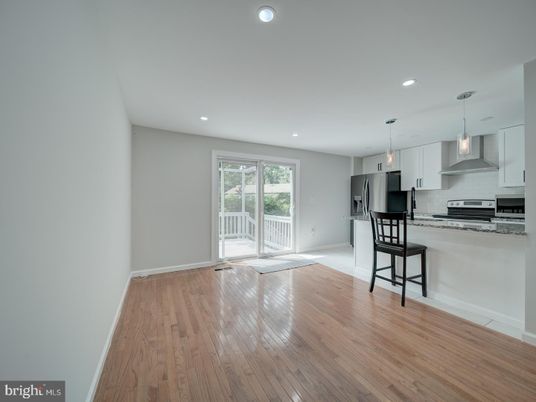 Empty room, Interior, Kitchen, Pendant Lights, Recessed Lighting, Stainless Steel Appliances, Wood Texture Flooring