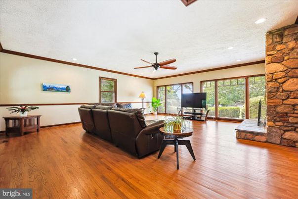 Fireplace, Interior, Living room, Recessed Lighting, Stone Walls, Wood Texture Flooring
