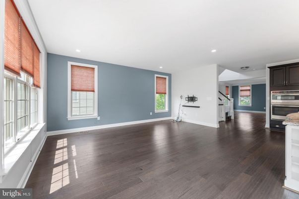 Empty room, Interior, Kitchen, Recessed Lighting, Stainless Steel Appliances, Wood Texture Flooring