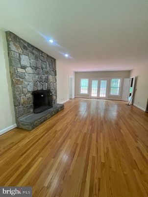 Empty room, Fireplace, Interior, Recessed Lighting, Stone Walls, Wood Texture Flooring