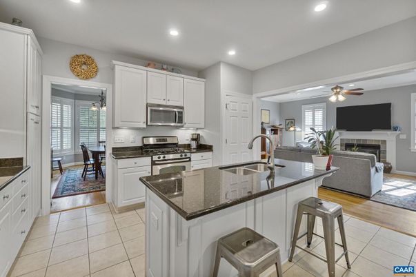 Dining room, Fireplace, Interior, Kitchen, Living room, Recessed Lighting, Stainless Steel Appliances, Wood Texture Flooring
