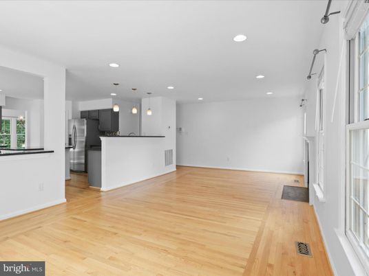 Empty room, Interior, Kitchen, Pendant Lights, Recessed Lighting, Stainless Steel Appliances, Wood Texture Flooring