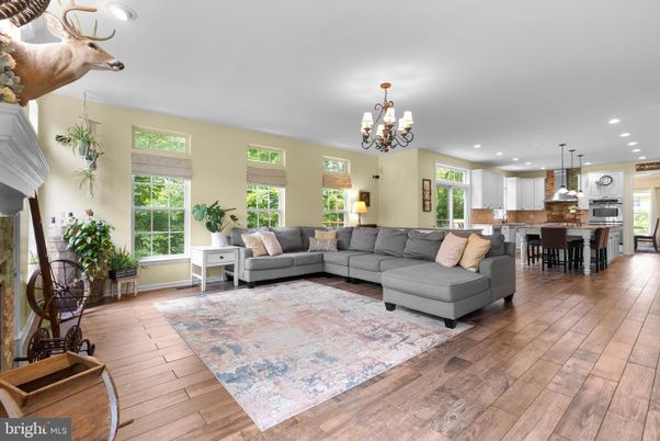 Chandelier, Dining room, Interior, Kitchen, Living room, Pendant Lights, Recessed Lighting, Stainless Steel Appliances, Wood Texture Flooring