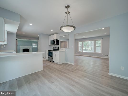 Empty room, Interior, Kitchen, Pendant Lights, Recessed Lighting, Stainless Steel Appliances, Wood Texture Flooring