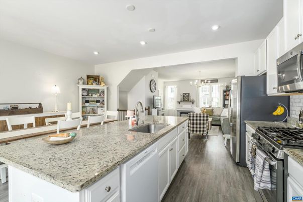Chandelier, Dining room, Interior, Kitchen, Living room, Pendant Lights, Recessed Lighting, Stainless Steel Appliances, Wood Texture Flooring