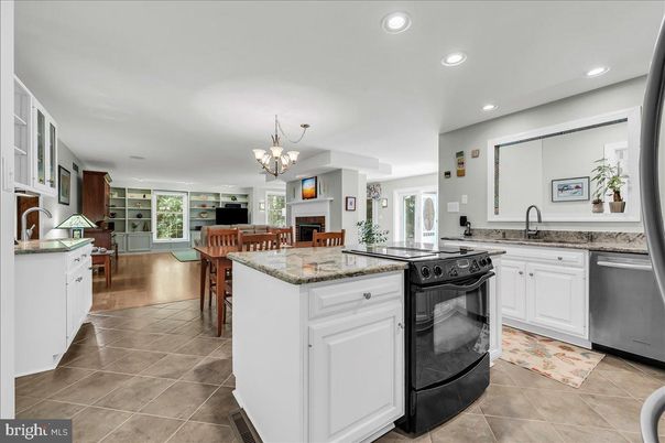 Chandelier, Dining room, Fireplace, Interior, Kitchen, Living room, Recessed Lighting, Stainless Steel Appliances