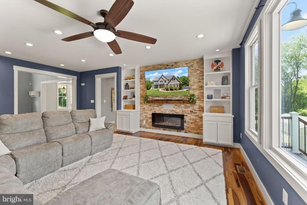 Fireplace, Interior, Living room, Recessed Lighting, Stone Walls, Wood Texture Flooring