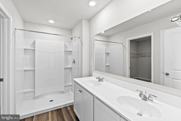 Bathroom, Dual Sink Vanities, Interior, Recessed Lighting, Walk-in Closets, Wood Texture Flooring