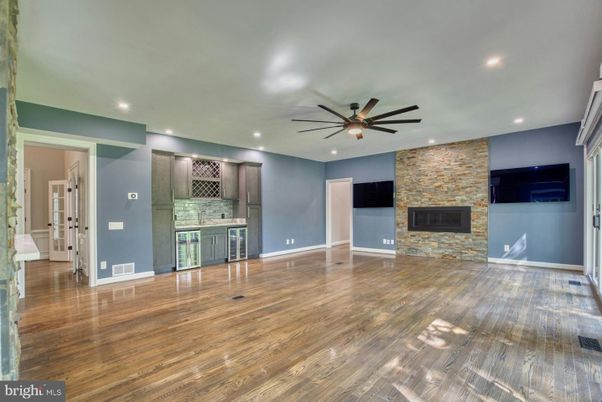 Empty room, Fireplace, Interior, Kitchen, Recessed Lighting, Stone Walls, Wood Texture Flooring