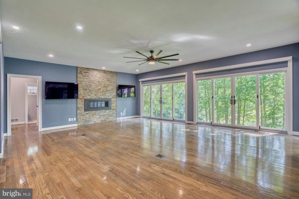 Empty room, Fireplace, Interior, Recessed Lighting, Stone Walls, Wood Texture Flooring