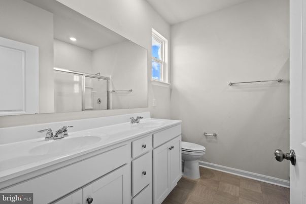 Bathroom, Dual Sink Vanities, Glass Shower, Interior, Recessed Lighting, Wood Texture Flooring
