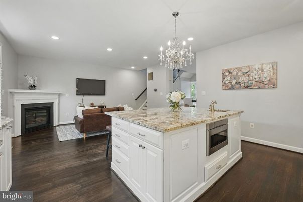 Chandelier, Fireplace, Interior, Kitchen, Living room, Recessed Lighting, Wood Texture Flooring