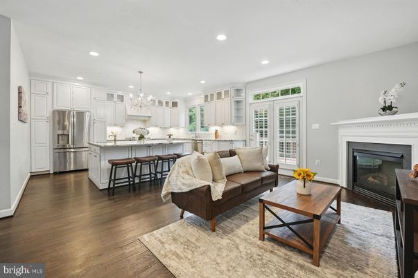 Chandelier, Fireplace, Interior, Kitchen, Living room, Recessed Lighting, Stainless Steel Appliances, Wood Texture Flooring
