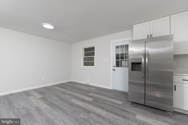 Empty room, Interior, Kitchen, Recessed Lighting, Stainless Steel Appliances, Wood Texture Flooring