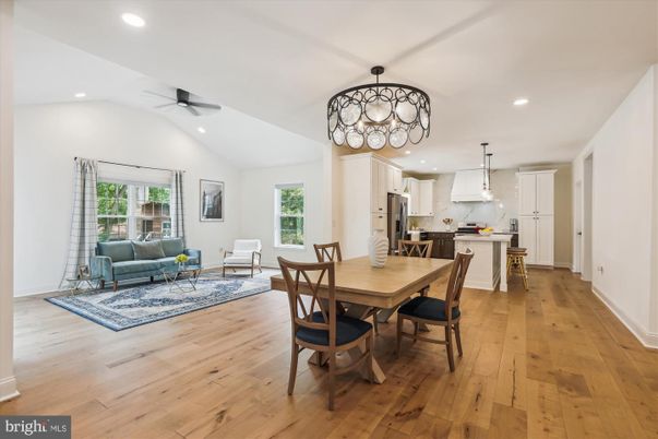 Chandelier, Dining room, Interior, Kitchen, Living room, Pendant Lights, Recessed Lighting, Stainless Steel Appliances, Wood Texture Flooring