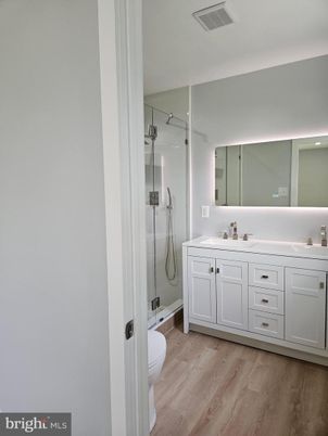 Bathroom, Dual Sink Vanities, Glass Shower, Interior, Recessed Lighting, Wood Texture Flooring