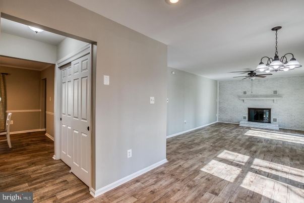 Empty room, Fireplace, Interior, Recessed Lighting, Stone Walls, Wood Texture Flooring
