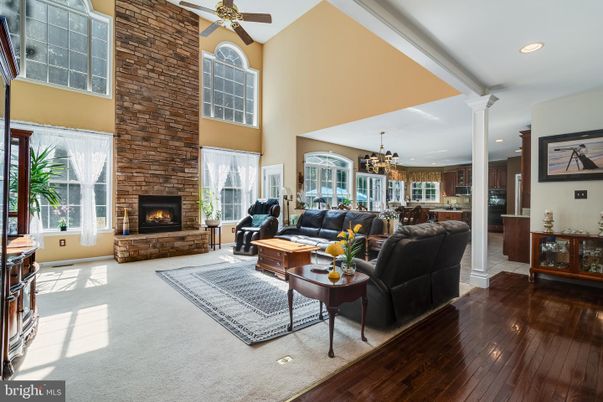 Chandelier, Fireplace, Interior, Kitchen, Living room, Recessed Lighting, Stone Walls, Wood Texture Flooring