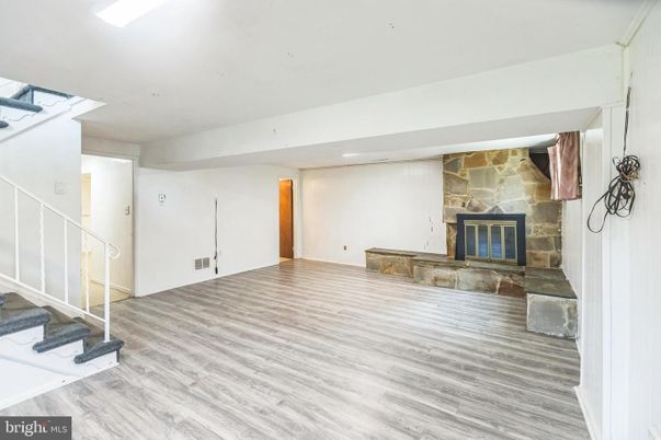 Empty room, Fireplace, Interior, Recessed Lighting, Stone Walls, Wood Texture Flooring