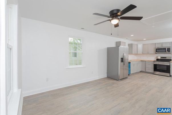 Empty room, Interior, Kitchen, Recessed Lighting, Stainless Steel Appliances, Wood Texture Flooring