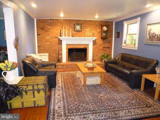 Fireplace, Interior, Living room, Recessed Lighting, Stone Walls, Wood Texture Flooring