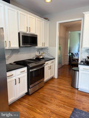 Interior, Kitchen, Marble Walls, Recessed Lighting, Stainless Steel Appliances, Wood Texture Flooring