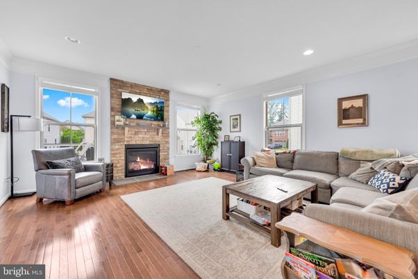 Fireplace, Interior, Living room, Recessed Lighting, Stone Walls, Wood Texture Flooring