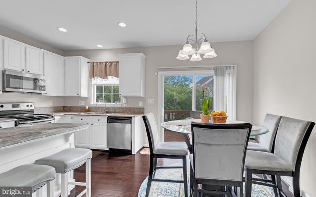 Chandelier, Dining room, Interior, Kitchen, Recessed Lighting, Stainless Steel Appliances, Wood Texture Flooring