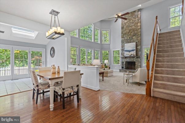 Chandelier, Dining room, Fireplace, Interior, Living room, Stone Walls, Wood Texture Flooring