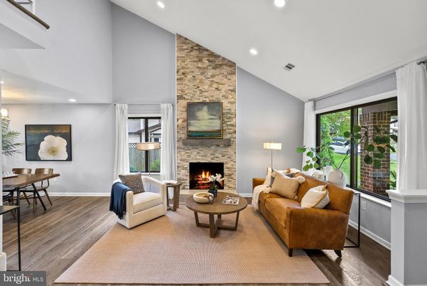 Dining room, Fireplace, Interior, Living room, Recessed Lighting, Stone Walls, Wood Texture Flooring