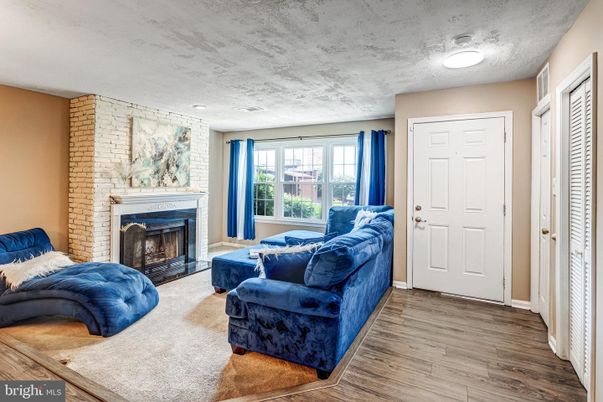 Fireplace, Interior, Living room, Recessed Lighting, Stone Walls, Wood Texture Flooring