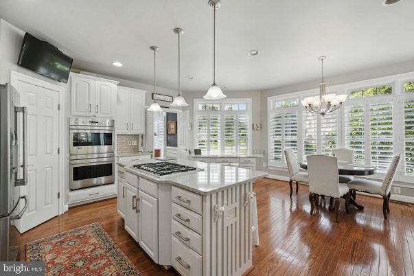 Chandelier, Dining room, Interior, Kitchen, Pendant Lights, Recessed Lighting, Stainless Steel Appliances, Wood Texture Flooring